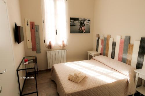 Habitación pequeña con cama y ventana en Le Stanze, en Bolonia