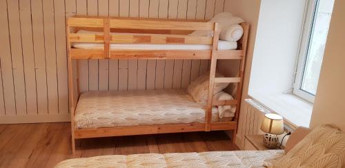 a room with two bunk beds in a room at Les 3 mômes in Pontorson
