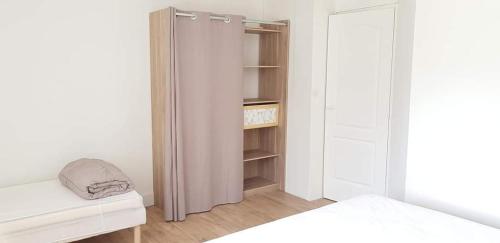 a small bedroom with a closet and a bed at Les 3 mômes in Pontorson