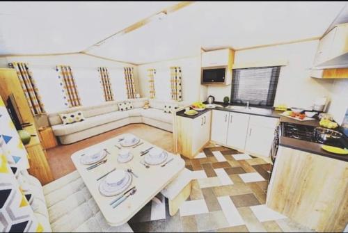 a kitchen with a white table in a room at Lido leisure park in Knaresborough