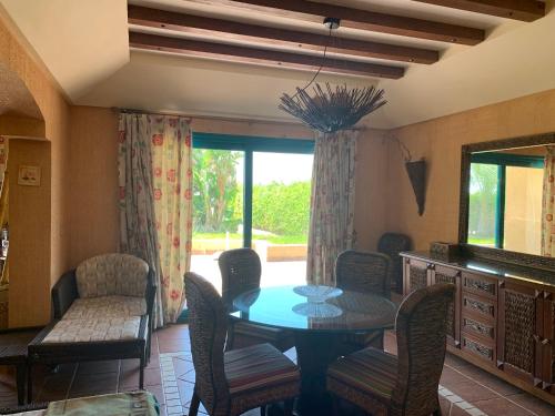 a dining room with a table and chairs at Ras Sedr Royal Beach Villa at Sinaway Lagoon Hotel & Spa- Ras Sedr, Egypt in Ras Sedr