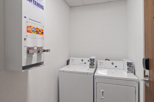 a laundry room with two washers and a dryer at Holiday Inn Express St. Augustine - Vilano Beach by IHG in Saint Augustine