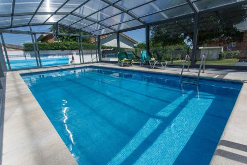 a large swimming pool with a clear cover over it at El Bulín de la Cabrera - Pico de la Miel in La Cabrera