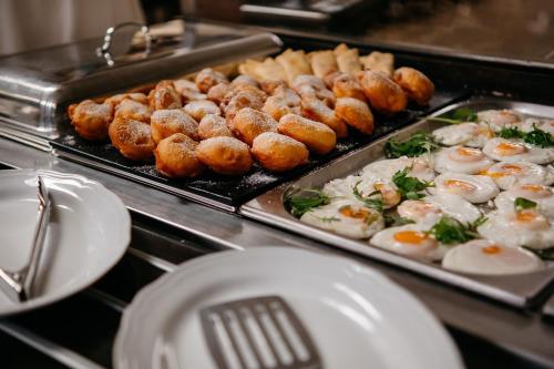 a buffet with eggs and other foods on trays at Family & Business Sauna Apartments No1 Leśny nad Zalewem Cedzyna Unikat - 3 Bedroom with Private Sauna, Bath with Hydromassage, Terrace, Garage, Catering Options in Kielce
