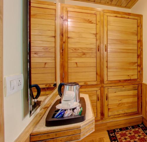 a kitchen with a blender on a wooden counter at The Holiday Resorts and Cottages in Manāli