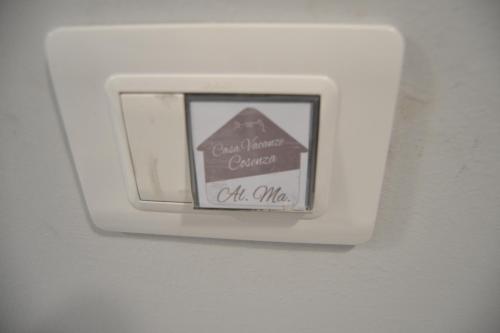 a lightswitch on a wall with a sign on it at Sara Home in Cosenza
