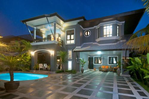 a villa with a swimming pool at night at Baan Santhiya Private Pool Villas - Free Tuk-Tuk Service to the Beach! in Ao Nang Beach