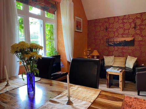 a living room with a table and a couch at Penmachno Hall - self catering suite in Betws-y-coed