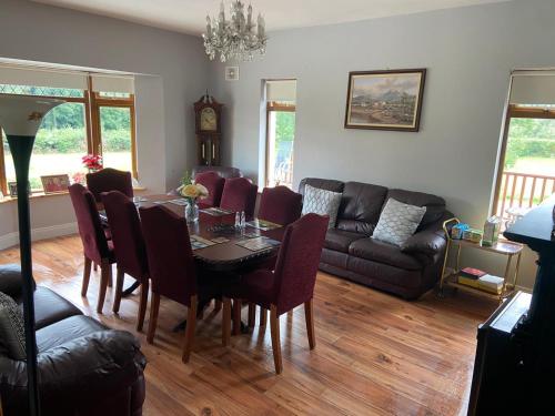 a living room with a table and a couch at Motorwaylodge Kilcoran Cahir E21RK60 in Cahir