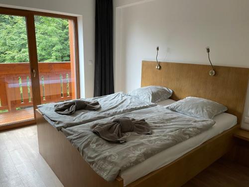 a bed with two pillows on it in a bedroom at Apartmanovy dom Romantika (Apt 21), Trangoska, Chopok Juh in Horná Lehota