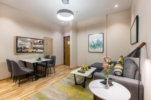 a living room with a couch and a table at Beata Garden in Al Khobar