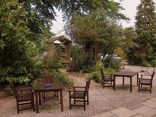 a group of tables and chairs in a garden at Fieldways in Trowbridge