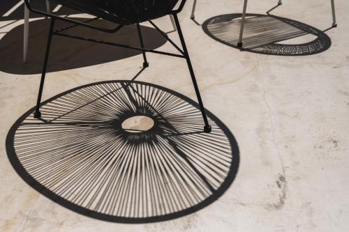 two black metal chairs sitting on a concrete floor at Casa di Melo - Organic Country Hotel in Cassibile