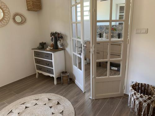 a room with a glass cabinet and a dresser at Maison avec piscine chauffée - 8 personnes - Sud Réunion in Saint-Joseph