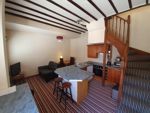 a kitchen and living room with a table and a couch at Tennyson Retreat in Lincoln