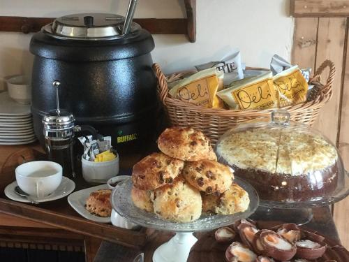 a table with a plate of biscuits and a basket of food at Balsporran Bed and Breakfast in Dalwhinnie