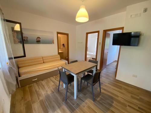 a living room with a table and a couch at Agriturismo I Tesori del Sud Vieste, Puglia in Vieste