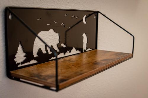 a piece of wood with a forest scene on a wall at Brownsville Motel in Brownsville