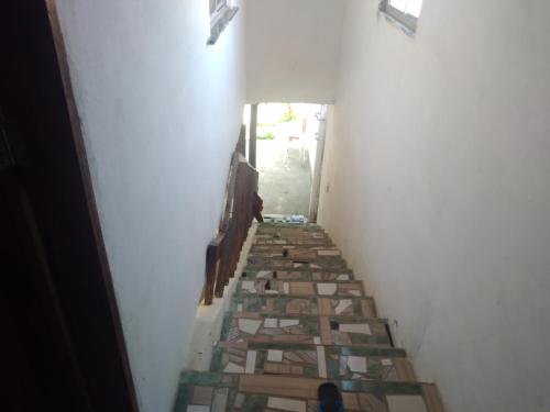 a hallway with stained glass tiles on the floor at Paracuru HolaOnda WaveHostel in Paracuru