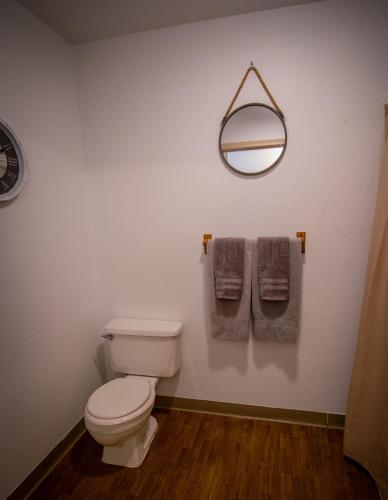 a bathroom with a toilet and a mirror on the wall at Brownsville Motel in Brownsville