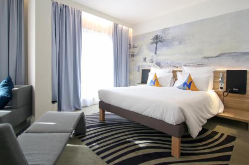 Un ou plusieurs lits dans un hébergement de l'établissement Novotel Tunis Lac