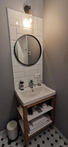 a bathroom with a sink and a mirror at PAMIŠKĖ BOUTIQUE SPA in Jokūbavas
