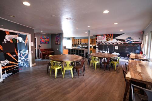 a dining room with two tables and chairs in a restaurant at California Dreams Hostel - Ocean Beach in San Diego