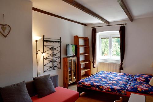 a bedroom with a bed and a window at Pension Hamry in Vranov nad Dyjí