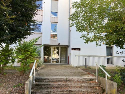 a white building with stairs in front of it at STUDIO DIJON MARPAUX in Dijon