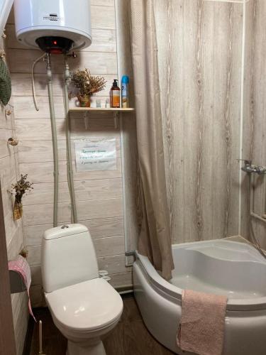 a bathroom with a toilet and a tub and a sink at Relax and chill Villa in Chornomorsk