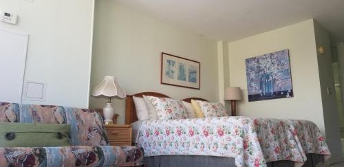a bedroom with a bed and a couch at Waikiki Studio at Ilikai Marina - great apartment by the beach in Honolulu