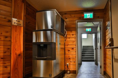 a kitchen with a stove in a room at Griz Inn by FantasticStay in Fernie