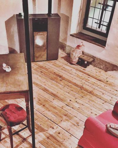 a living room with a wood floor and a fireplace at La torretta in Pessinetto