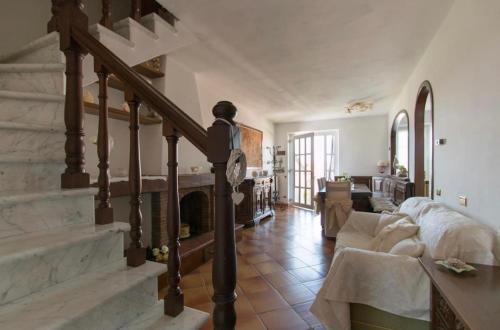 a living room with a staircase and a fireplace at Splendida e incantevole casa a due passi dal mare in Viareggio