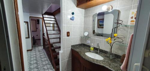 a bathroom with a sink and a mirror at Casa Charmosa in Paraty