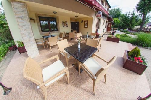 a patio with tables and chairs on a patio at Dwa Bratanki in Rzeszów
