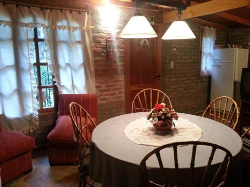 a room with a table with a vase of flowers on it at Cabañas La Caldera in La Caldera