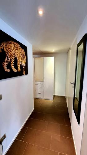 a hallway with a painting of a leopard on the wall at Maison Marquet in Cap d'Ail