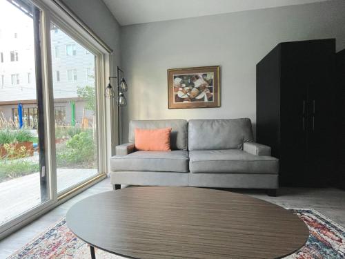 a living room with a couch and a table at Sleepover 1BD 1BA Omaha Apartments in Omaha