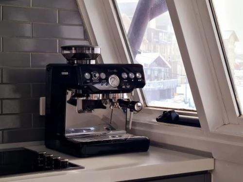 a coffee maker sitting on a counter next to a window at Red Robin in Mount Hotham