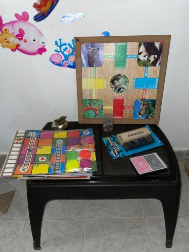 a table with books and other items on it at Edificio Agustin in Bahía Solano