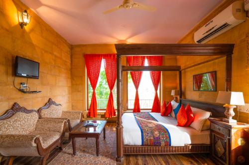 a bedroom with a bed and a couch in a room at Hotel Helsinki House in Jaisalmer