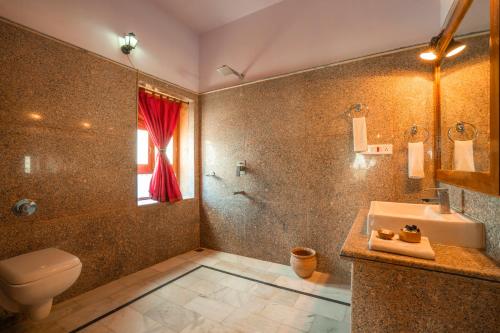 a bathroom with a toilet and a sink and a shower at Hotel Helsinki House in Jaisalmer