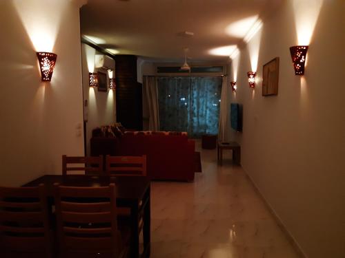 a living room with a couch and a table and lights at German Dolphin in Quseir