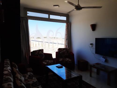 a living room with a large window and a couch at German Dolphin in Quseir