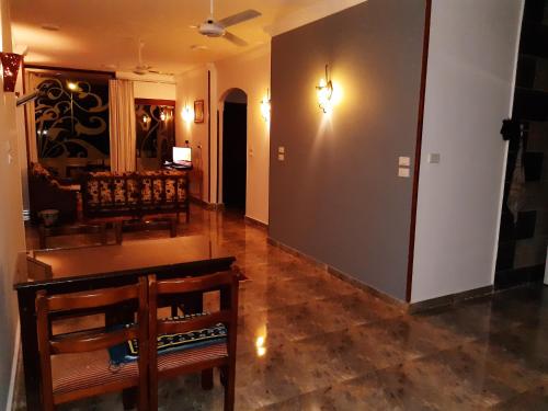 a dining room and living room with a table and chairs at German Dolphin in Quseir