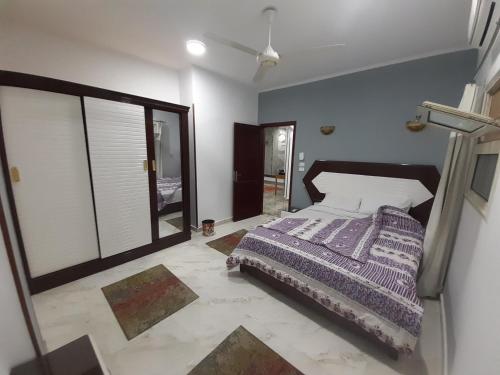 a bedroom with a bed and a large window at German Dolphin in Quseir