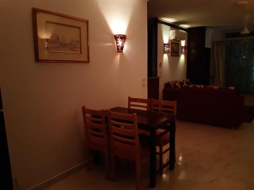 a dining room with a table and chairs and a couch at German Dolphin in Quseir