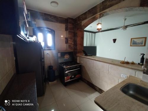 a kitchen with a sink and a stove in it at German Dolphin in Quseir