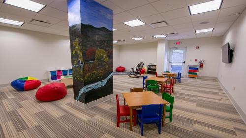 a classroom with tables and chairs and a painting on the wall at Holiday Inn Express Gatlinburg Downtown by IHG in Gatlinburg